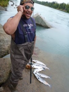 A young man in Soldotna displays his sockeye catch. (3 caught in 10 minutes that we watched.)